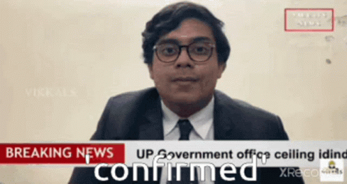 Man In Suit And Tie Talking In Front Of Breaking News Sign GIF