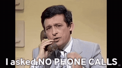 Man In Suit And Tie Talking On Phone GIF
