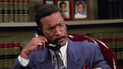 Man In Suit And Tie Talking On Phone GIF