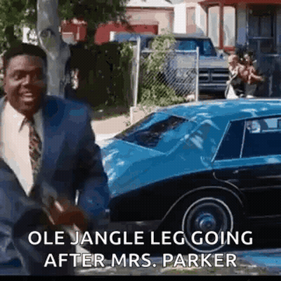 Man In Suit And Tie Talking To Blue Car GIF