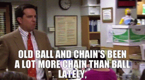 Man In Suit And Tie Talking To Woman In Pink Sweater GIF