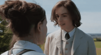 Man In Suit And Tie Talks To Woman GIF