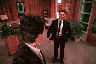 Man In Suit And Tie Talks To Woman GIF
