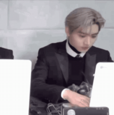 Man In Suit And Tie Using Laptop GIF