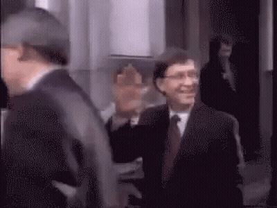 Man In Suit And Tie Walking Down Hallway GIF