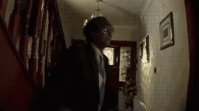 Man In Suit And Tie Walking Down Hallway GIF