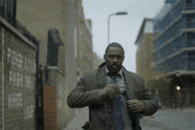 Man In Suit And Tie Walking Down Street GIF