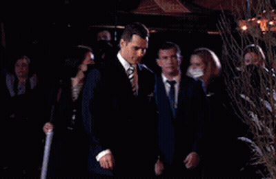 Man In Suit And Tie Walking In Front Of Crowd GIF
