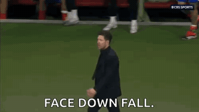 Man In Suit And Tie Walking On Soccer Field GIF