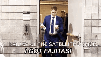 Man In Suit And Tie Walking Through Door Holding Bottle Of Water GIF