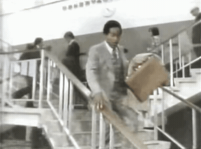 Man In Suit And Tie Walking Up Stairs GIF