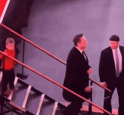 Man In Suit And Tie Walking Up Stairs With Child GIF