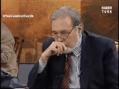 Man In Suit And Tie Watching Haber Turk GIF