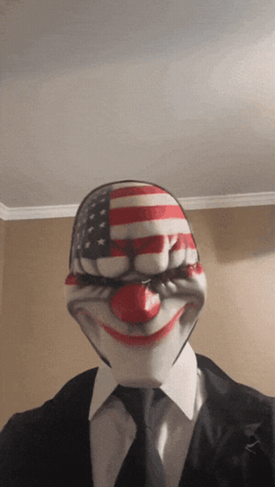 Man In Suit And Tie Wearing Clown Mask GIF