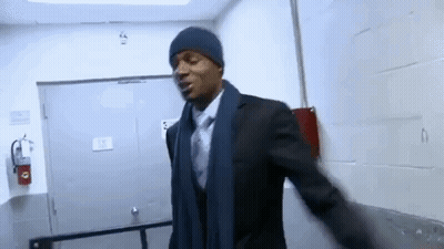 Man In Suit And Tie Wearing Hat And Scarf In Hallway GIF