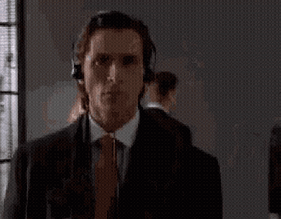 Man In Suit And Tie Wearing Headphones GIF