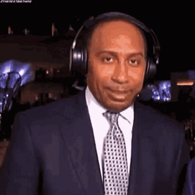 Man In Suit And Tie Wearing Headphones GIF