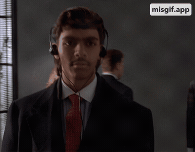 Man In Suit And Tie Wearing Headphones GIF