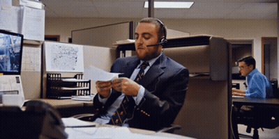 Man In Suit And Tie Wearing Headset Looking At Paper GIF