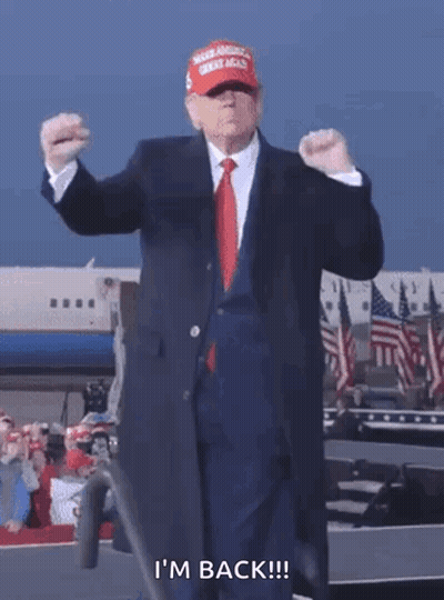 Man In Suit And Tie Wearing MAGA Hat Says I'm Back GIF