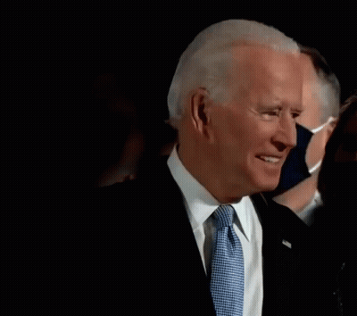 Man In Suit And Tie Wearing Mask GIF