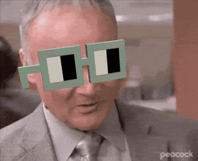 Man In Suit And Tie Wearing Peacock Sunglasses GIF