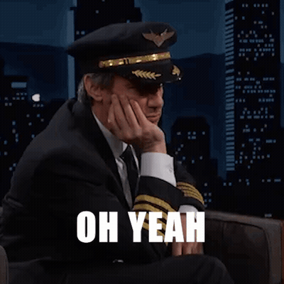 Man In Suit And Tie Wearing Pilot Hat GIF