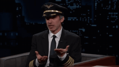 Man In Suit And Tie Wearing Pilot Hat GIF