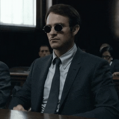 Man In Suit And Tie Wearing Sunglasses GIF