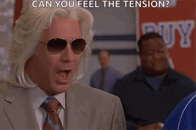 Man In Suit And Tie Wearing Sunglasses Saying Can You Feel The Tension GIF