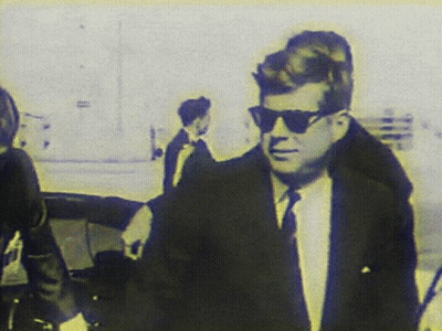 Man In Suit And Tie Wearing Sunglasses Walking GIF