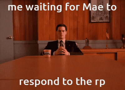Man In Suit And Tie With Coffee By Wooden Wall GIF