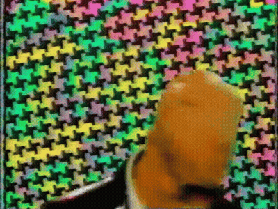 Man In Suit And Tie With Colorful Geometric Pattern GIF