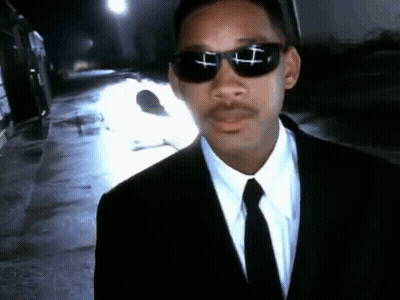 Man In Suit And Tie With Cross Sunglasses GIF