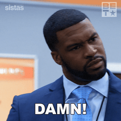 Man In Suit And Tie With Damn On Face GIF