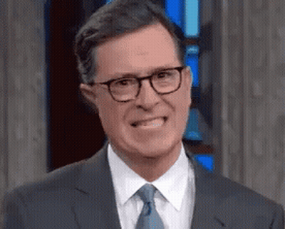 Man In Suit And Tie With Glasses Making Funny Face GIF