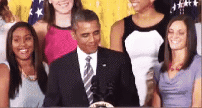 Man In Suit And Tie With Group Of Women GIF