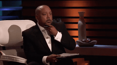 Man In Suit And Tie With Hand On Chin GIF