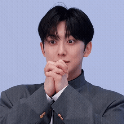 Man In Suit And Tie With Hands Folded Covering Mouth GIF
