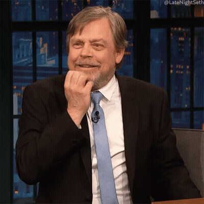 Man In Suit And Tie With Hashtag Latenightseth GIF