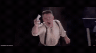 Man In Suit And Tie With He's Back Sign GIF