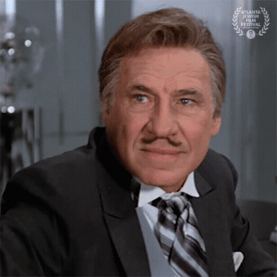 Man In Suit And Tie With Laurel Wreath GIF