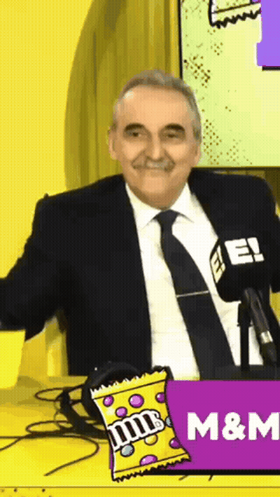 Man In Suit And Tie With M&M Candy GIF