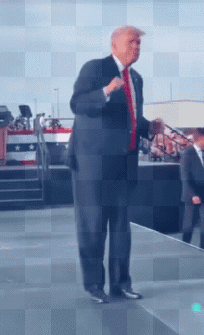 Man In Suit And Tie With Microphone On Stage GIF