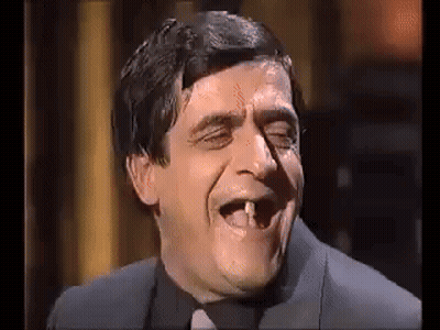 Man in Suit and Tie With Missing Tooth