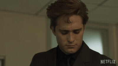 Man In Suit And Tie With Netflix Logo GIF