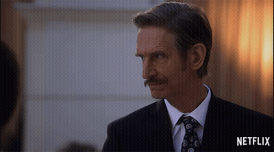 Man In Suit And Tie With Netflix Logo GIF