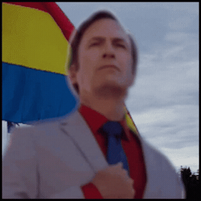 Man In Suit And Tie With Rainbow Flag GIF