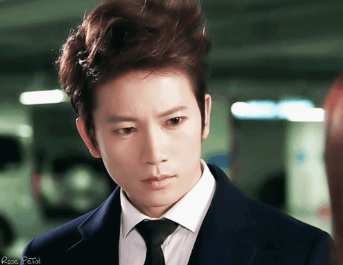 Man In Suit And Tie With Rose Petal GIF
