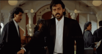 Man In Suit And Tie With Suresh Productions Logo GIF